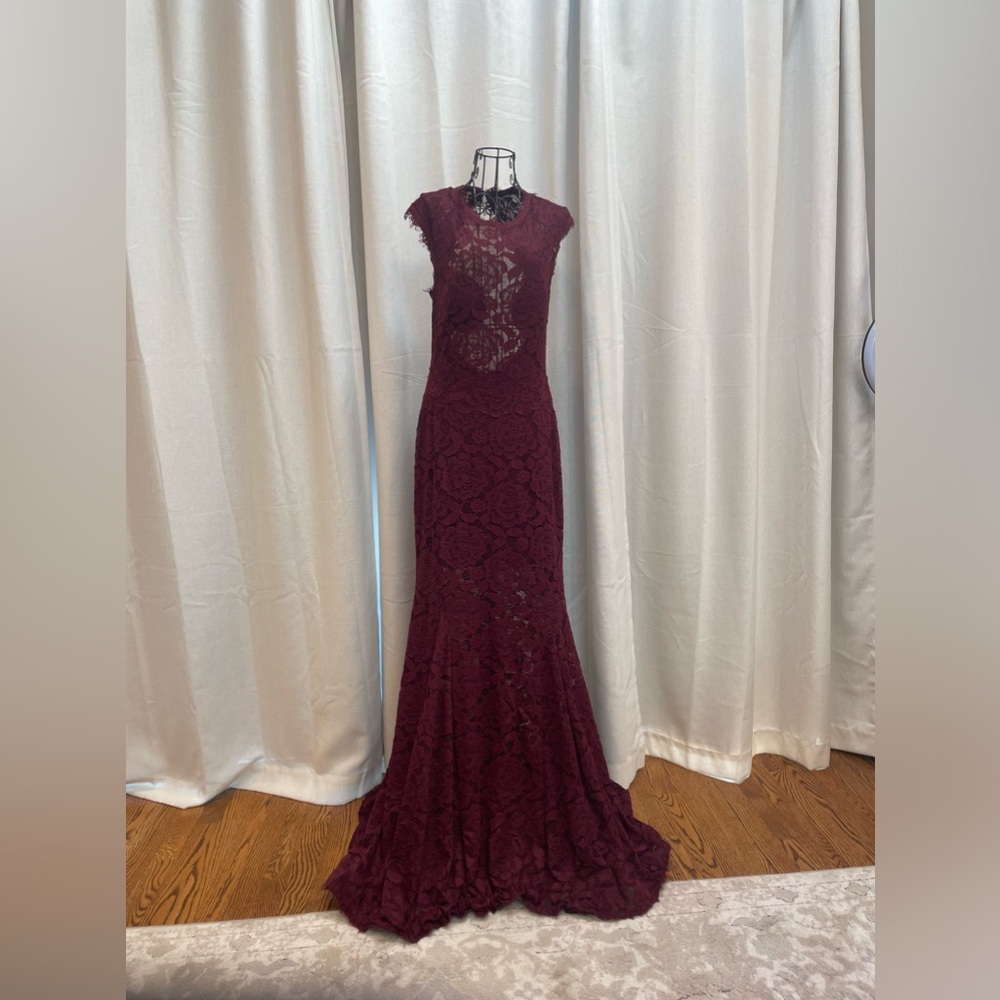 Long with short train gown. Worn as a wedding guest. Maroon